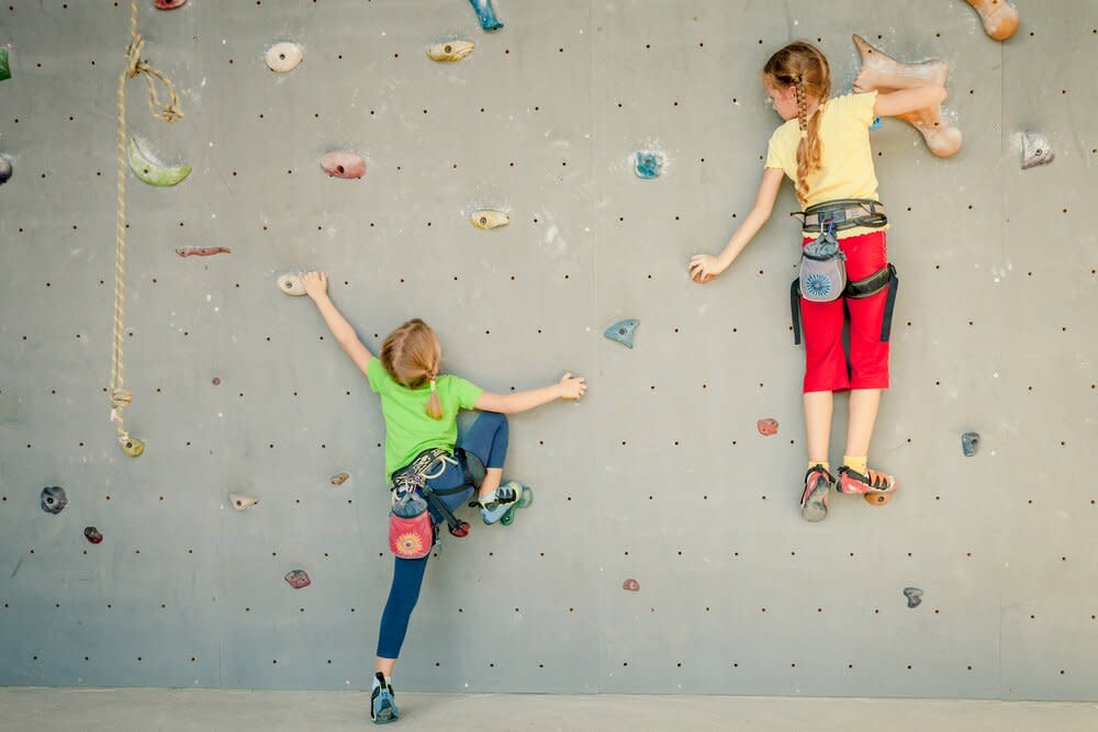 two young girls rock climbing