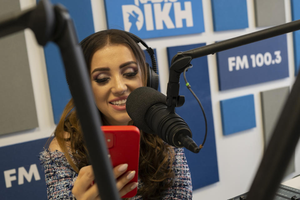 Melanie Nagy, co-host of Radio Dikh's women's show 'Zsa Shej' works in a radio studio in Budapest, Hungary, Friday May 6, 2022. Intellectuals, broadcasters and cultural figures from Hungary’s Roma community have founded a radio station to reframe narratives and elevate the voices of their marginalized minority group. (AP Photo/Bela Szandelszky)