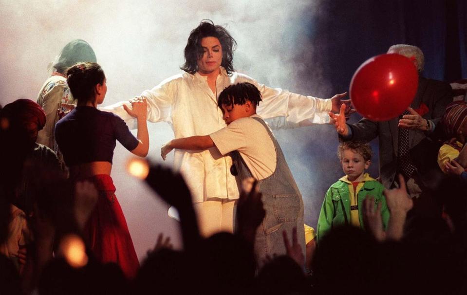 Jackson vs Cocker: In 1996 Michael Jackson was given a special Artist of a Generation award. At the ceremony he accompanied his single Earth Song with a stage show, culminating with Jackson as a Christ-like figure surrounded by children. (Fiona Hanson/PA)