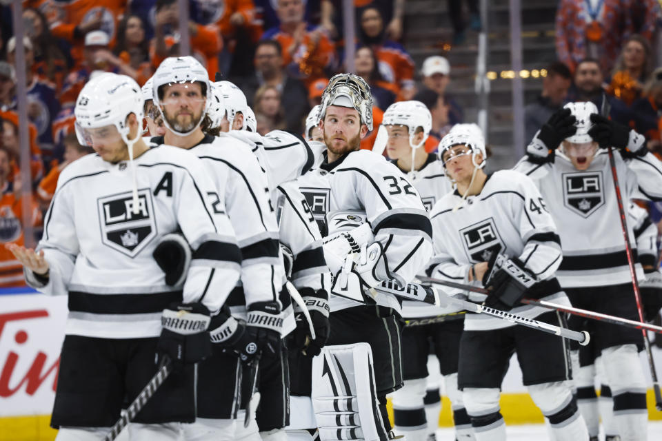 Los Angeles Kings goalie Jonathan Quick (32) and teammates watch as Edmonton Oilers celebrate after Game 7 of a first-round series in the NHL hockey Stanley Cup playoffs Saturday, May 14, 2022, in Edmonton, Alberta. (Jeff McIntosh/The Canadian Press via AP)