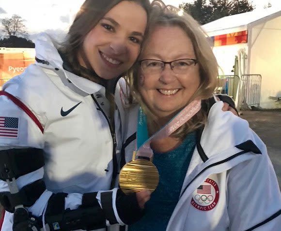 Oksana showing off one of her medals with her mother - Oksana Masters