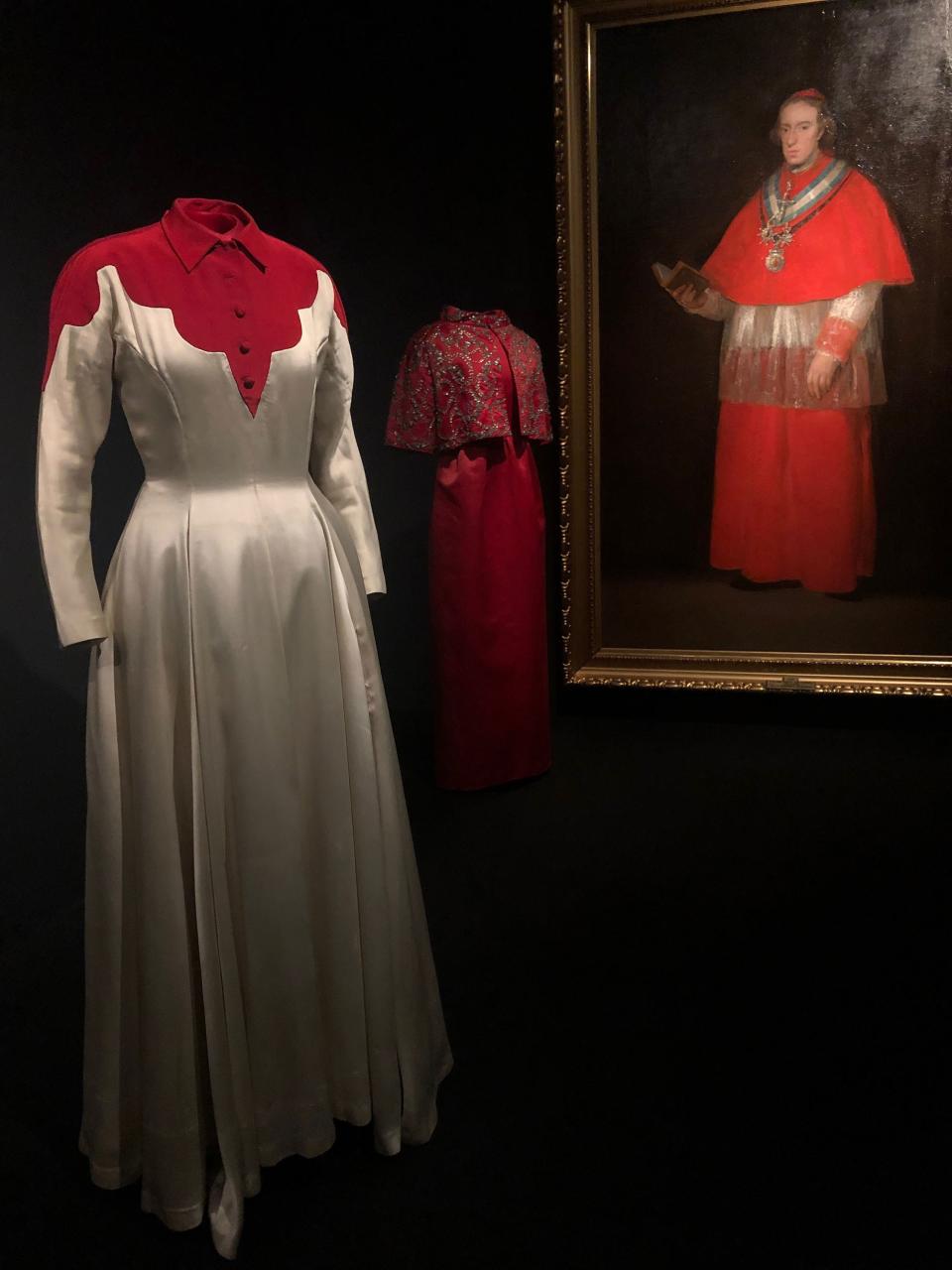 At front, Balenciaga's Infanta dress from 1939, with Francisco de Goya’s Cardinal Luis Maria de Borbon y Vallabriga, c. 1800. (In the background is a beaded satin ensemble from 1960.)