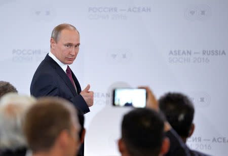 Russian President Vladimir Putin gestures as he arrives for a meeting with businessmen on the sidelines of the Russia-ASEAN summit in Sochi, Russia, May 20, 2016. Host photo agency via Reuters