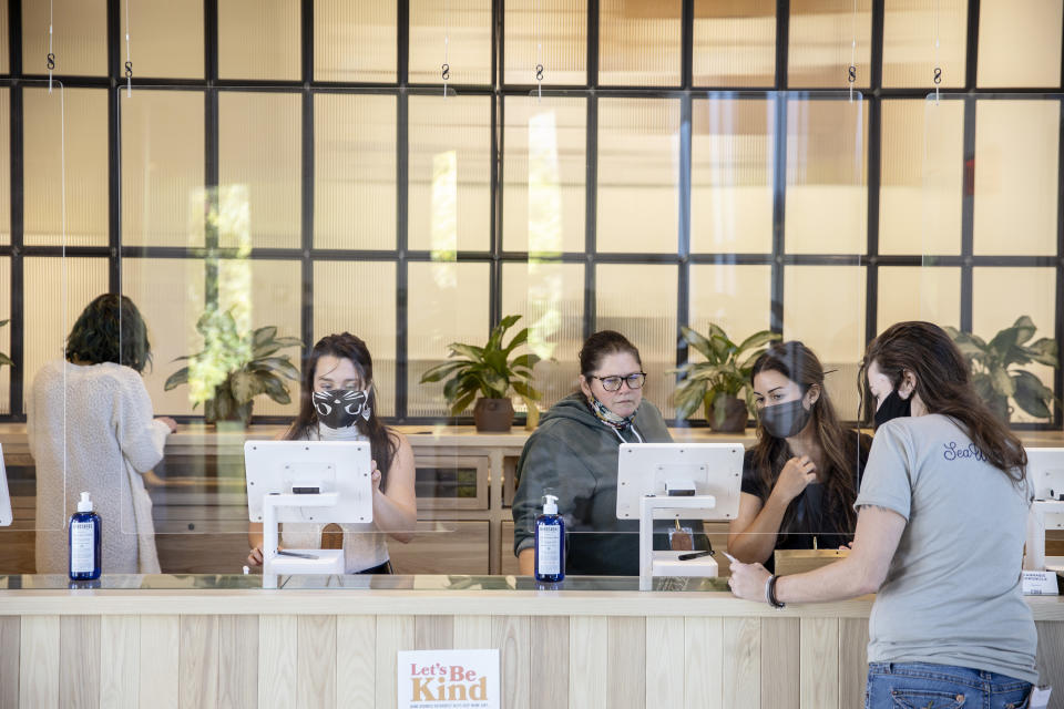 SOUTH PORTLAND, ME - OCTOBER 9: Employees ring up customers at SeaWeed Co. on the first day of recreational marijuana sales on Friday, October 9, 2020. (Staff photo by Brianna Soukup/Portland Press Herald via Getty Images)