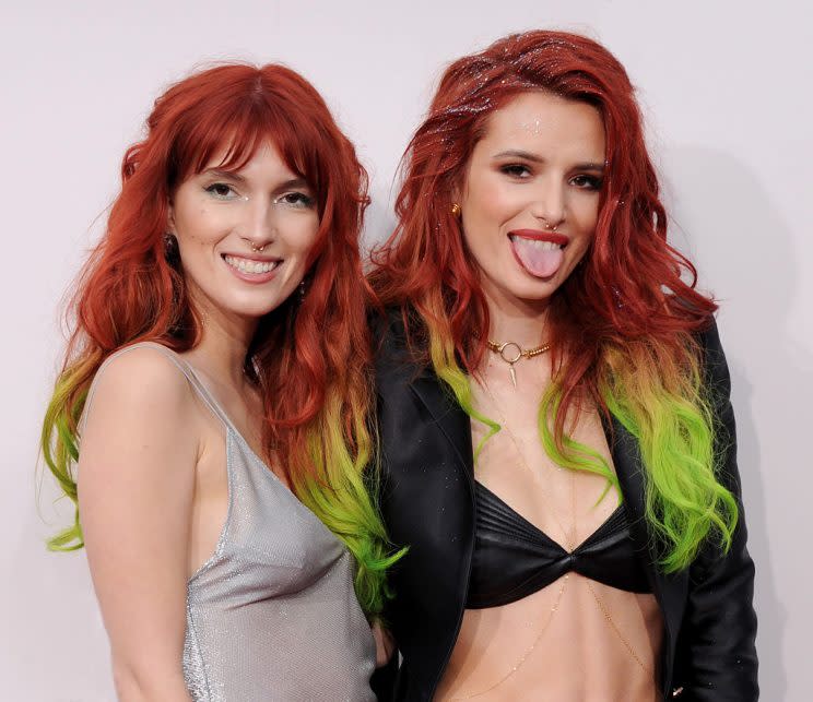 Actress Bella Thorne, right, and sister Dani Thorne rocked the same red and green ombre hair. (Photo: Getty Images)