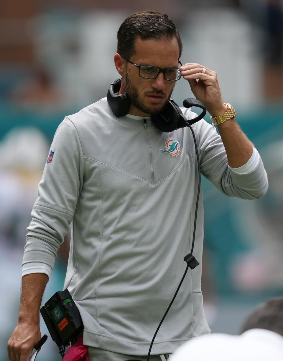 Miami Dolphins coach Mike McDaniel walks onto the field during the first half.
