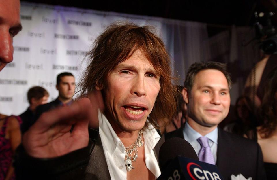 BOSTON, MA - SEPTEMBER 21:  Aerosmith singer Steven Tyler (C) and Niche Media CEO Jason Binn attend the launch of Boston Common Magazine September 21, 2005 in Boston Massachusetts. The new, upscale lifestyle magazine debuted today with Aerosmith singer Steven Tyler on the cover.  (Photo by Darren McCollester/Getty Images)