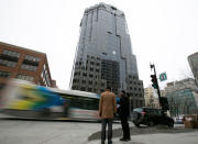 Pedestrians wait to cross the street in front of the SNC-Lavalin Group Inc., headquarters in Montreal, Quebec, Canada, February 12, 2019. REUTERS/Christinne Muschi