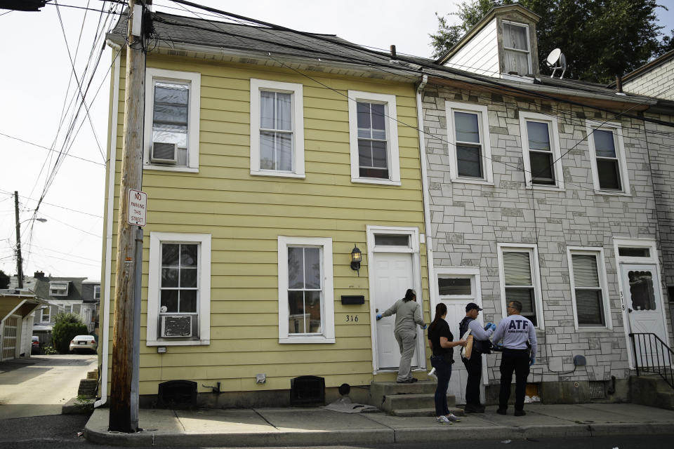 Investigators depart a home near the scene of Saturday's fatal car explosion in Allentown, Pa., Monday, Oct. 1, 2018. (AP Photo/Matt Rourke)