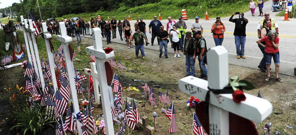 FILE - In this July 6, 2019, file photo, motorcyclists visit a memorial for seven bikers killed in a collision with a pickup truck last month while participating in the Ride for the Fallen 7 in Randolph, N.H. In a preliminary report released Wednesday, July 24, 2019, the National Transportation Safety Board summarized the details behind the June 21 crash in which a pickup truck driven by Volodymyr Zhukovskyy crashed into the bikers in Randolph, N.H. The report affirms early reports that Zhukovskyy crossed the center of the road and collided with the bikers.(Paul Hayes/Caledonian-Record via AP, File)