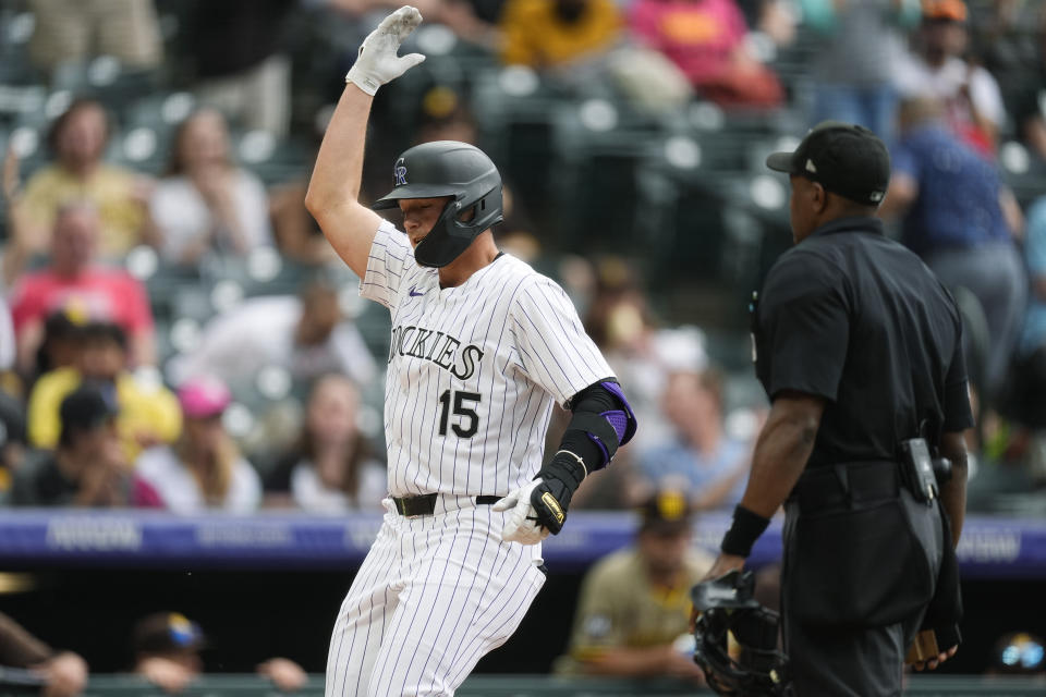 Colorado Rockies' Hunter Goodman gestures as he crosses home plate after hitting a three-run home run off San Diego Padres relief pitcher Wandy Peralta in the eighth inning of a baseball game Thursday, April 25, 2024, in Denver. (AP Photo/David Zalubowski)