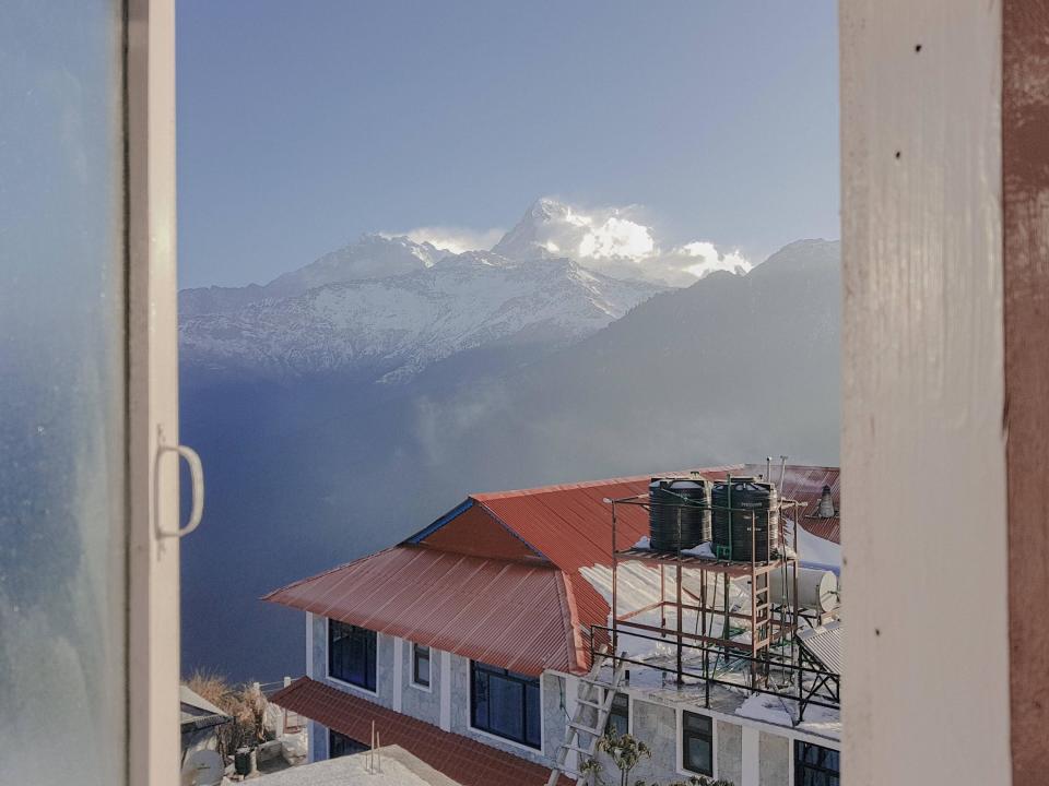 A view of the Himalayas in the distance from a window in Nepal