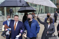 Michael Skakel, center, looks on as an attorney talks to reporters outside a courthouse in Stamford, Conn., Friday, Oct. 30, 2020. A Connecticut prosecutor says the Kennedy cousin will not face a second trial in the 1975 murder of teenager Martha Moxley in Greenwich. Chief State's Attorney Richard Colangelo Jr. made the announcement Friday at the state courthouse in Stamford. (AP Photo/Seth Wenig)