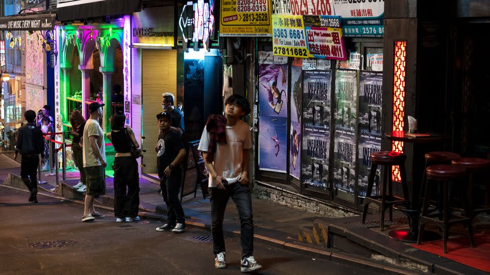 A man walks past a closed bar along a near-empty street in the Soho area of Hong Kong. - Noemi Cassanelli/CNN