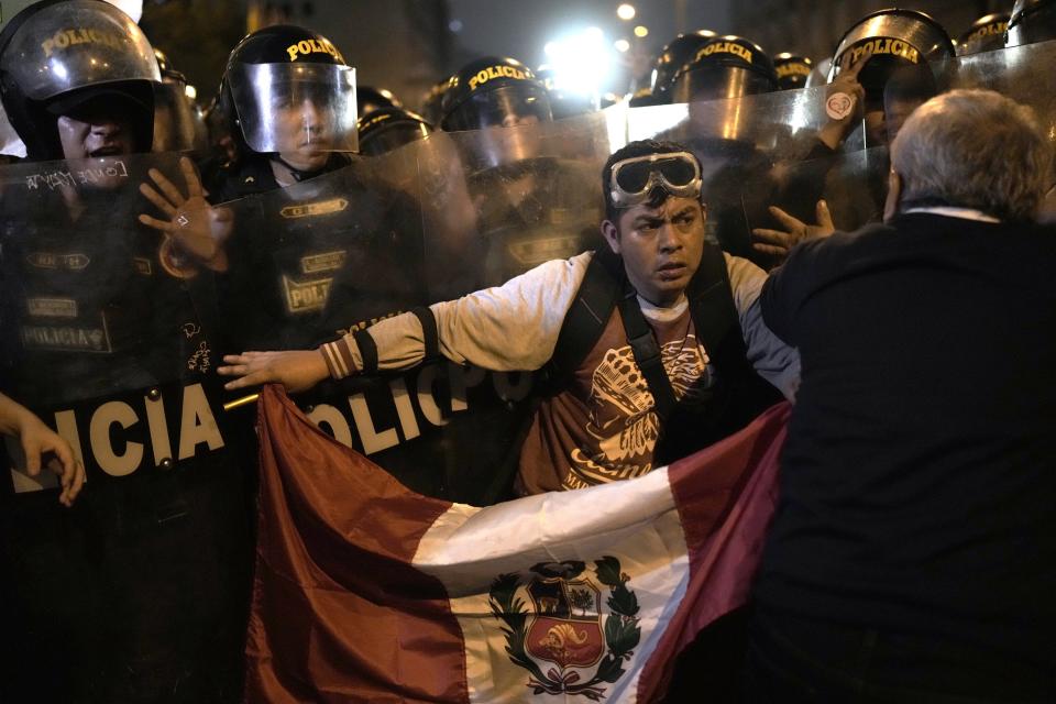 Manifestantes de oposición se enfrentan a un cordón policial en el centro de Lima, Perú, el miércoles 19 de julio de 2023. La protesta exige a la presidenta peruana Dina Boluarte un adelanto electoral inmediato, así como justicia por los muertos en las manifestaciones que sucedieron a la destitución de Pedro Castillo como presidente. (AP Foto/Rodrigo Abd)