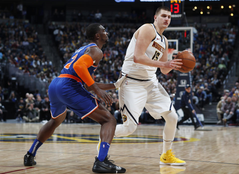 Denver Nuggets center Nikola Jokic, right, is defended by New York Knicks forward Noah Vonleh during the second half of an NBA basketball game Tuesday, Jan. 1, 2019, in Denver. The Nuggets won 115-108. (AP Photo/David Zalubowski)