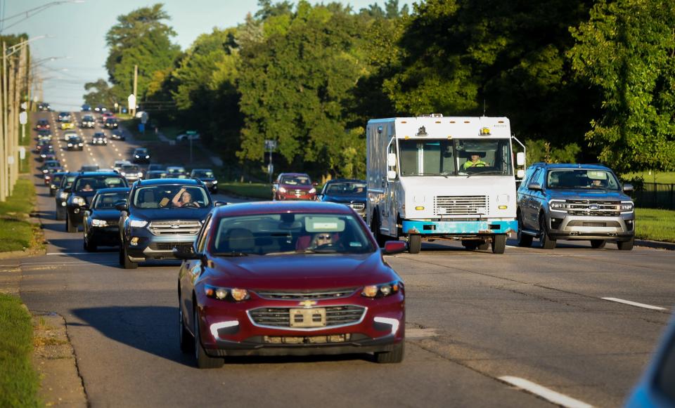 Traffic moves down Saginaw Street near Marshall Street in front of Lansing Eastern High School, Thursday morning, Aug. 31, 2023.