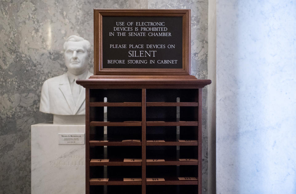 A storage unit for phones stands next to the entrance of the Senate chamber on Tuesday, Jan. 21. Electronic devices are not allowed in the chamber for the Senate impeachment trial. (Photo: Bill Clark via Getty Images)