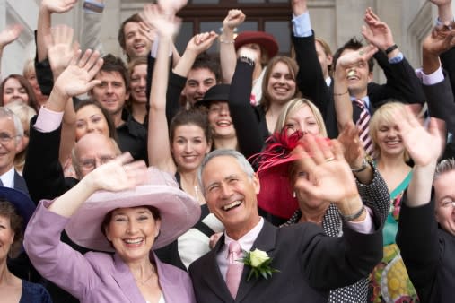 Happy wedding guests cheering at wedding