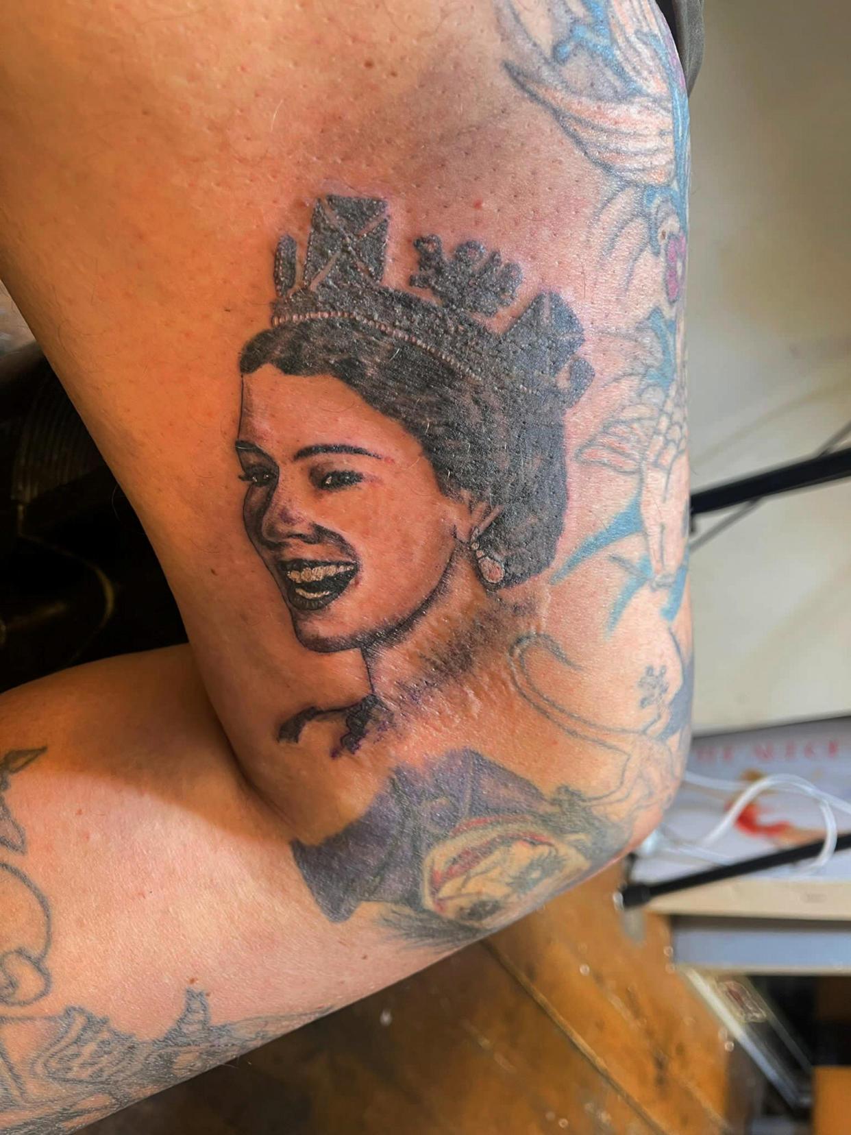 Pictured Michael Purkiss's tattoo. A tattoo artist has tattooed a portrait of the Queen on his leg to pay tribute to her, as they share the same birthday. See SWNS story SWLNtattoo. Michael Purkiss, 57, was so upset by the death of Queen Elizabeth II that he decided to tattoo a portrait of her just above his leg knee. He decided to get the tattoo as he has the same birthday as the Queen, and he used to joke with people that every year she would send him a cake. Michael was also 'really sad' when he found out the Queen had passed away. 