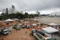 Workers work on areas of infrastructure next to the construction site of the Arena das Dunas stadium, in Natal May 10, 2014. REUTERS/Nuno Guimaraes