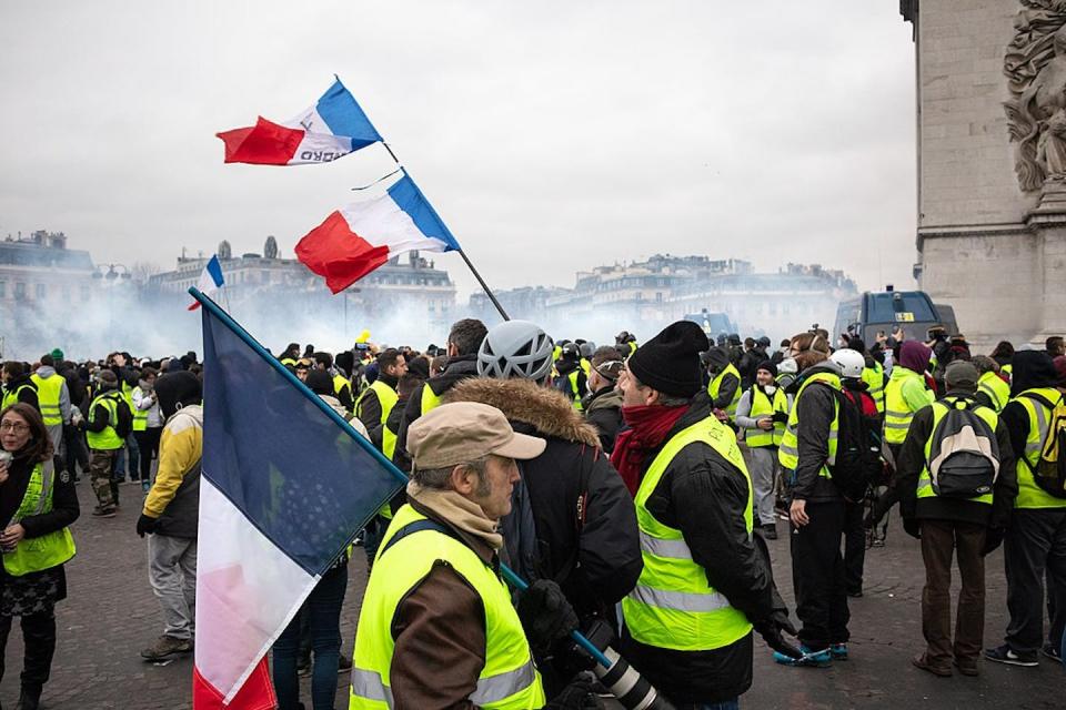Yellow vests’ protest in Paris in January 2019. <a href="https://upload.wikimedia.org/wikipedia/commons/thumb/3/34/Paris%2C_Gilets_Jaunes_-_Acte_IX_%2846724068321%29.jpg/1024px-Paris%2C_Gilets_Jaunes_-_Acte_IX_%2846724068321%29.jpg" rel="nofollow noopener" target="_blank" data-ylk="slk:Wikimedia;elm:context_link;itc:0;sec:content-canvas" class="link ">Wikimedia</a>, <a href="http://creativecommons.org/licenses/by-sa/4.0/" rel="nofollow noopener" target="_blank" data-ylk="slk:CC BY-SA;elm:context_link;itc:0;sec:content-canvas" class="link ">CC BY-SA</a>