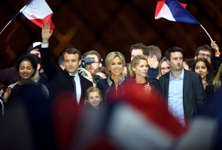 Emmanuel Macron with his wife Brigitte and members of her family at a victory party after his resounding win over far-right rival Marine Le Pen