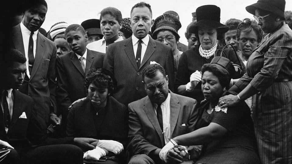 The family of Carole Robertson, a 14-year-old African American girl killed in a church bombing, attend graveside services for her, Sept. 17, 1963, Birmingham, Ala. Seated left to right: Carol Robertsons sister Dianne and parents, Mr. Alvin Robertson Sr. and Mrs. Alpha Robertson. The others are unidentified. (AP Photo/Horace Cort) - Horace Cort/AP