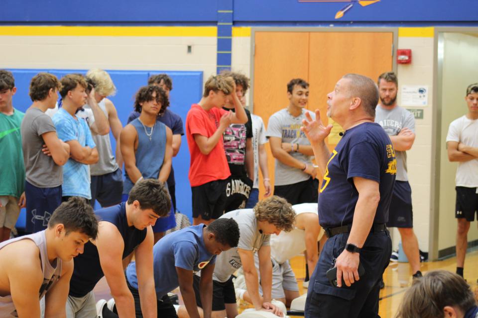 Instructed by Stephen Zimmerman, Eastern Lebanon County School District students in sets of 12 practiced multiple times on CPR manikins.