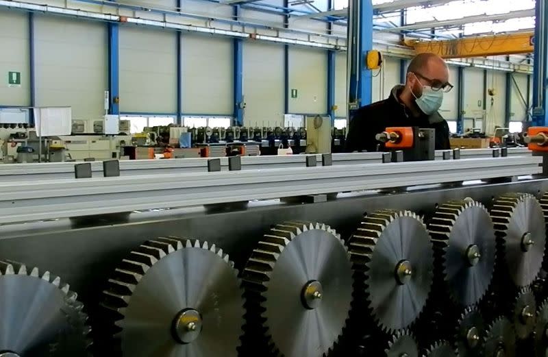 A worker wears a protective face mask in a factory of roll-forming machine maker Gasparini, in Mirano