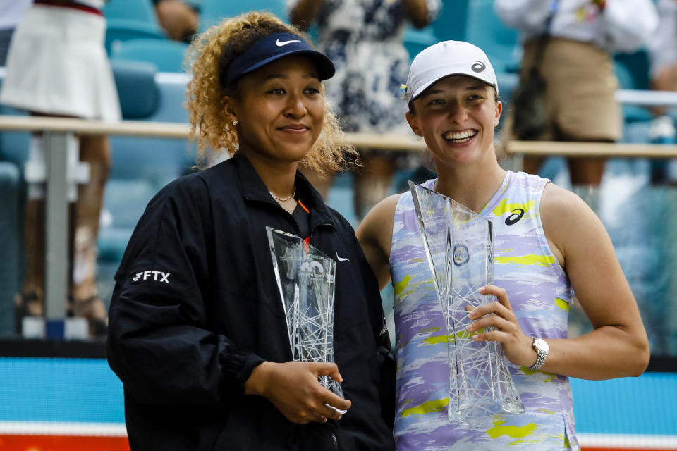 Naomi Osaka and Iga Swiatek, pictured here posing with their trophies after the Miami Open final.