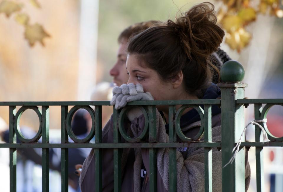 Linda Zapor of New Britain watches as Central Connecticut State University is in lockdown in New Britain, Connecticut November 4, 2013. A person has been taken into custody at Central Connecticut State University on Monday after officials locked down the campus when a suspicious person, possibly armed, was spotted, said New Britain Mayor Tim O'Brien. Citing students, local media said police had searched for a person who appeared to be carrying a gun and what looked like a sword. (REUTERS/Michelle McLoughlin)