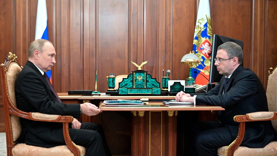 Russian President Vladimir Putin, left, listens to the head of the Russian Federal Antimonopoly Service Maxim Shaskolsky during their meeting in Moscow, Russia, Tuesday, Jan. 10, 2023. (Mikhail Klimentyev, Sputnik, Kremlin Pool Photo via AP)