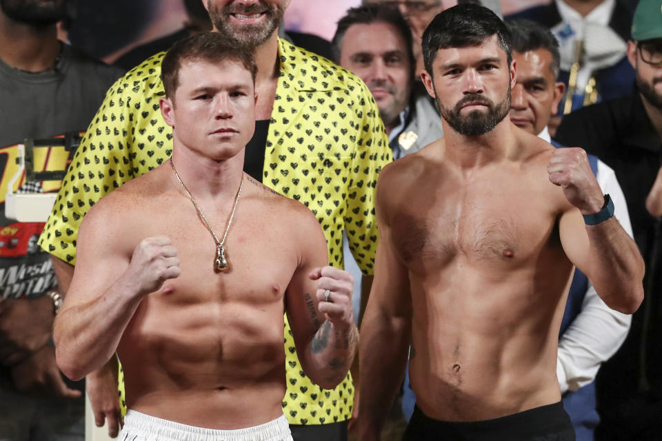 Boxers Saul "Canelo" Alvarez of Mexico, left, and John Ryder of Britain, pose for photos other during their weigh-in ceremony in Guadalajara, Mexico, Friday, May 5, 2023. Alvarez and Ryder will meet for a super middleweight championship fight at Akron Stadium on May 6. (AP Photo/Refugio Ruiz)