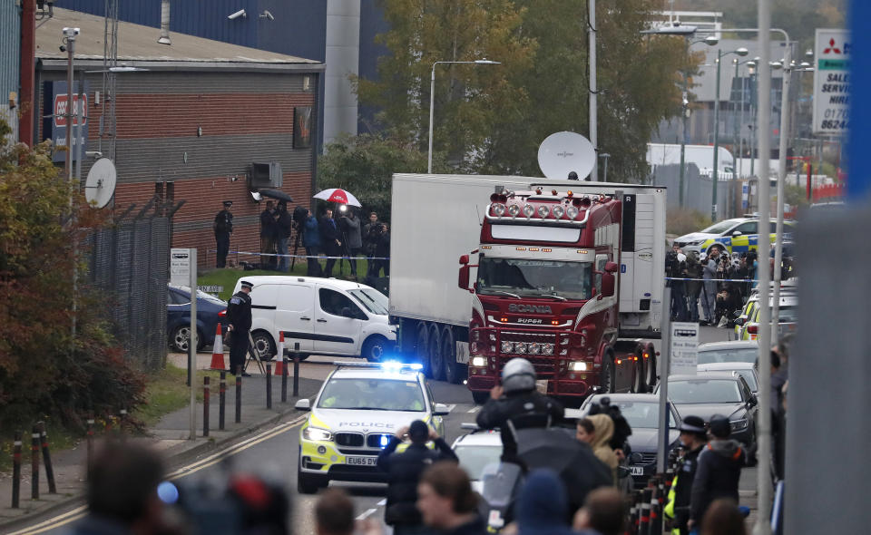 Police escort the truck, that was found to contain a large number of dead bodies, as they move it from an industrial estate in Thurrock, south England, Wednesday Oct. 23, 2019. Police in southeastern England said that 39 people were found dead Wednesday inside a truck container believed to have come from Bulgaria. (AP Photo/Alastair Grant)