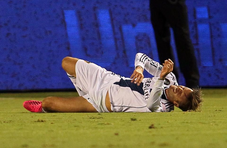 CARSON, CA - SEPTEMBER 01: David Beckham #23 of the Los Angeles Galaxy grimaces on the pitch after rolling his ankle in the first half during the MLS match against the Vancouver Whitecaps at The Home Depot Center on September 1, 2012 in Carson, California. The Galaxy defeated the Whitecaps 2-0. (Photo by Victor Decolongon/Getty Images)