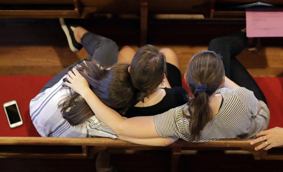 People comfort each other during a vigil at Fisk University to protest the execution of Billy Ray Irick Thursday, Aug. 9, 2018, in Nashville, Tenn. Tennessee carried out the execution of Irick, condemned for the 1985 rape and murder of a 7-year-old girl, marking the first time the state has applied the death penalty since 2009. (AP Photo/Mark Humphrey)