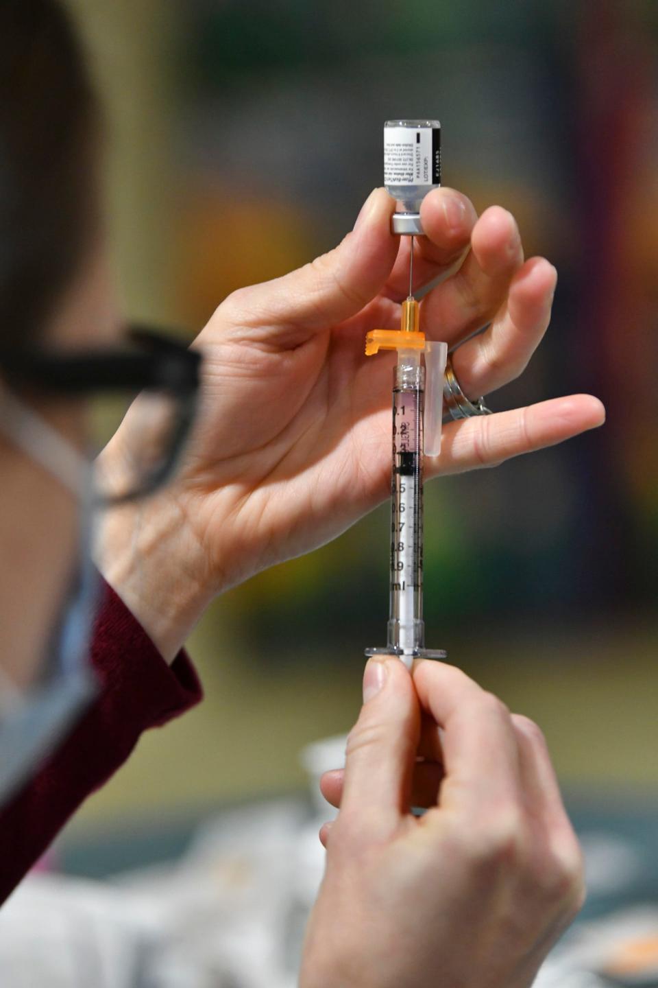 Nurse practitioner Mandy Krippner prepares one of the first few doses of the Pfizer COVID-19 vaccine to be given to staff members Thursday Dec. 17, 2020, at the St. Cloud Hospital.   