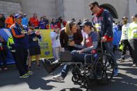 Actor Kevin Spacey (L) cheers on as 2013 Boston Marathon bombing survivor Rebekah Gregory DiMartino (2nd R) crosses the marathon finish line during a Tribute Run for survivors and first responders in Boston, Massachusetts April 19, 2014. The 118th running of the Boston Marathon will be held on April 21. REUTERS/Brian Snyder (UNITED STATES - Tags: SPORT ATHLETICS ENTERTAINMENT)