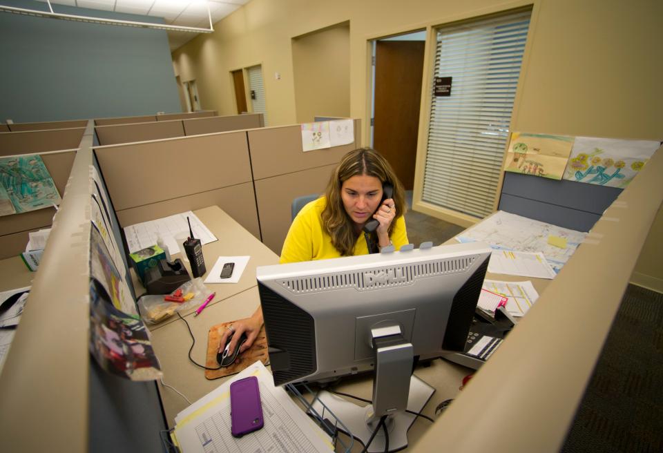 Jennifer Osteen, a customer care agent with the Indian River County's GoLine and Community Coach services, takes a phone call from someone needing to book a trip with Community Coach on Feb. 8, 2013. The service was given $2,281,044 in the form of an American Recovery and Reinvestment Act grant for a new transit administration building and bus garage in 2012.