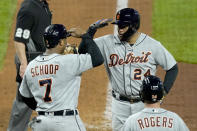 Detroit Tigers' Miguel Cabrera (24) celebrates with Jonathan Schoop (7) after hitting a grand slam during the seventh inning of a baseball game against the Kansas City Royals Friday, May 21, 2021, in Kansas City, Mo. (AP Photo/Charlie Riedel)