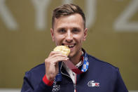 Gold medalist Jean Quiquampoix, of France, celebrates after the men's 25-meter rapid fire pistol at the Asaka Shooting Range in the 2020 Summer Olympics, Monday, Aug. 2, 2021, in Tokyo, Japan. (AP Photo/Alex Brandon)