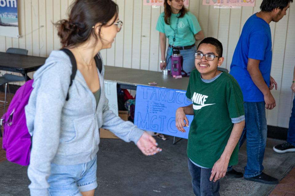 Mary Grett Transition Center and TIDES program student Daniel Alvarez hands "kindness bracelets" to university students to promote the Best Buddies program at Texas A&M University-Corpus Christi on Feb. 22, 2023. TIDES, which stands for Teaching Independence, Empowerment and Determination Skills, is a university program that aims to help young adults with disabilities develop independent living skills.