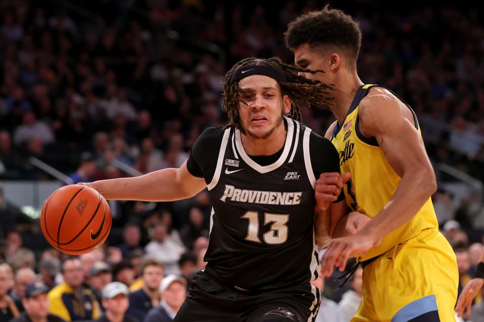 Providence Friars forward Josh Oduro (13) controls the ball against Marquette Golden Eagles forward Oso Ighodaro (13) during the first half at Madison Square Garden on Friday night.
