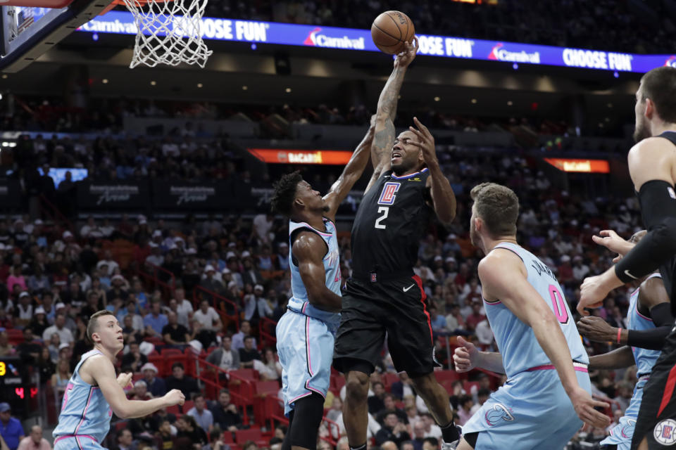 Los Angeles Clippers forward Kawhi Leonard (2) drives to the basket as Miami Heat forward Jimmy Butler defends during the first half of an NBA basketball game, Friday, Jan. 24, 2020, in Miami. (AP Photo/Lynne Sladky)