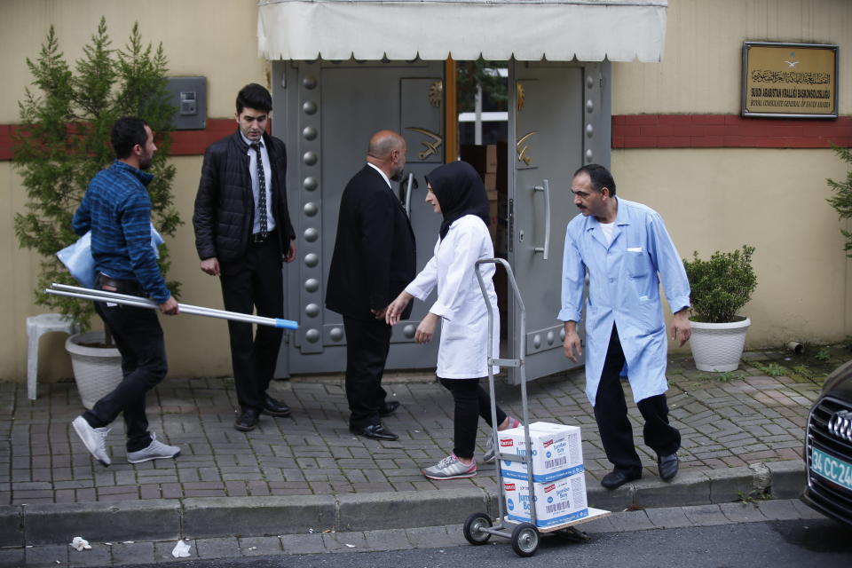 Cleaning personnel wait to enter Saudi Arabia's Consulate in Istanbul, Monday, Oct. 15, 2018. Turkey says an "inspection" of the consulate is expected to take place later on Monday, nearly two weeks after Saudi journalist after Jamal Khashoggi disappeared there. (AP Photo/Petros Giannakouris)