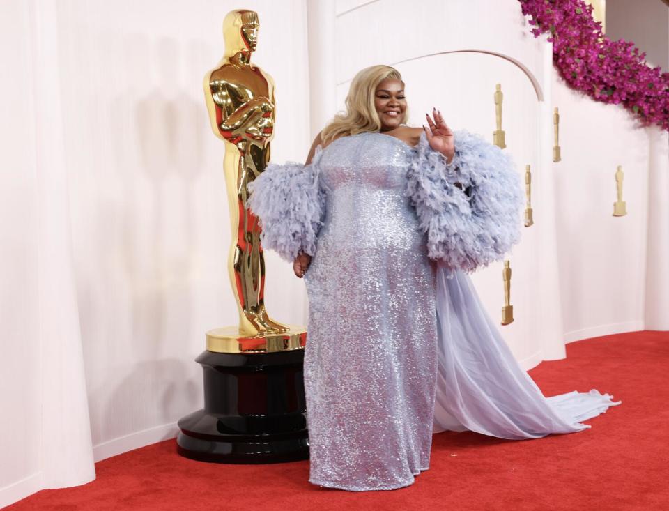 Da'Vine Joy Randolph wears a baby blue sequined dress with feathers.