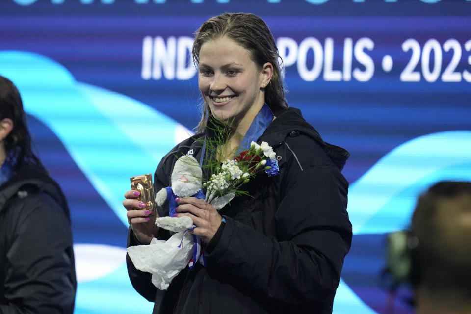 Katharine Berfkoff smiles on the awards stand after winning the women's 50-meter backstroke at the U.S. national championships swimming meet in Indianapolis, Thursday, June 29, 2023. (AP Photo/Michael Conroy)