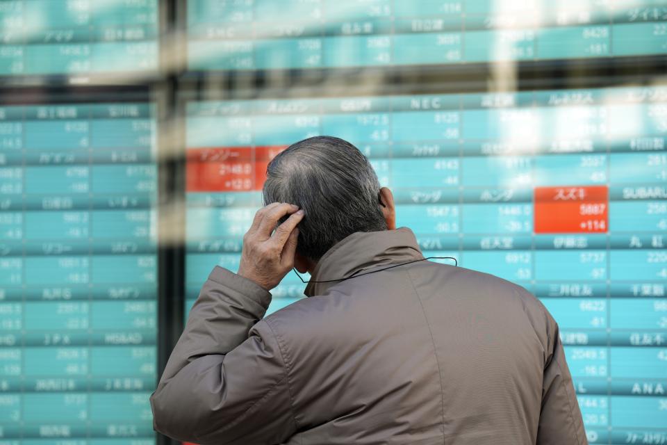 FILE - A person looks at an electronic stock board showing Japan's stocks' prices at a securities firm in Tokyo, Dec. 21, 2023. Asian shares powered higher on Thursday, Dec. 28 with Chinese benchmarks up more than 1%, after Wall Street logged modest gains in this holiday-shortened week. (AP Photo/Eugene Hoshiko, File)