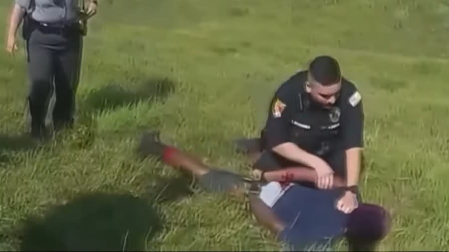 Jadarrius Rose, 23, who was operating a semi-tractor trailer on U.S. Route 35, is shown being detained by Ohio State Highway Patrol after a Circleville officer sicced a police dog on him. (Photo: Screenshot/YouTube.com/WKYC Channel 3)